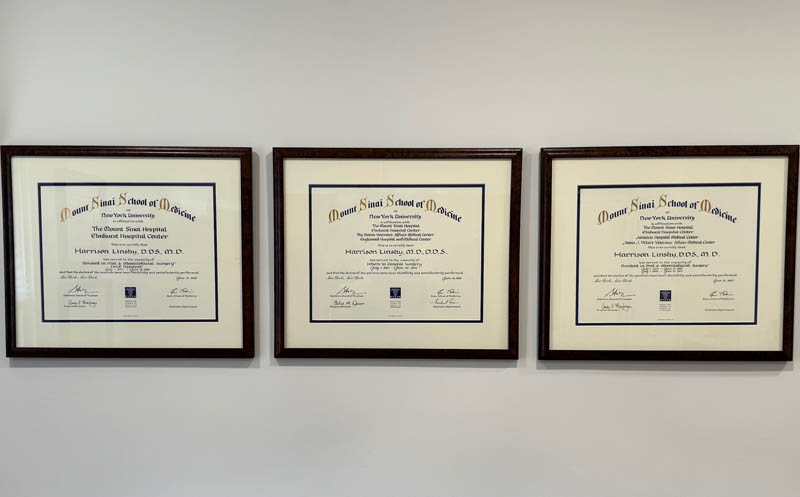 The image shows three framed diplomas hanging on a wall, each with text and decorative elements, indicating academic achievement or certifications.